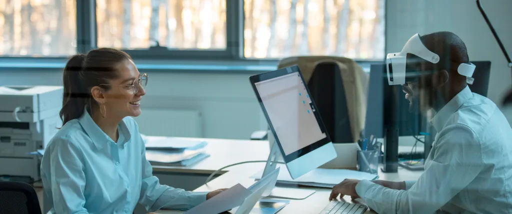 Hombre y mujer usando gafas de realidad virtual en programa de MBA con IA generativa en IAU Madrid