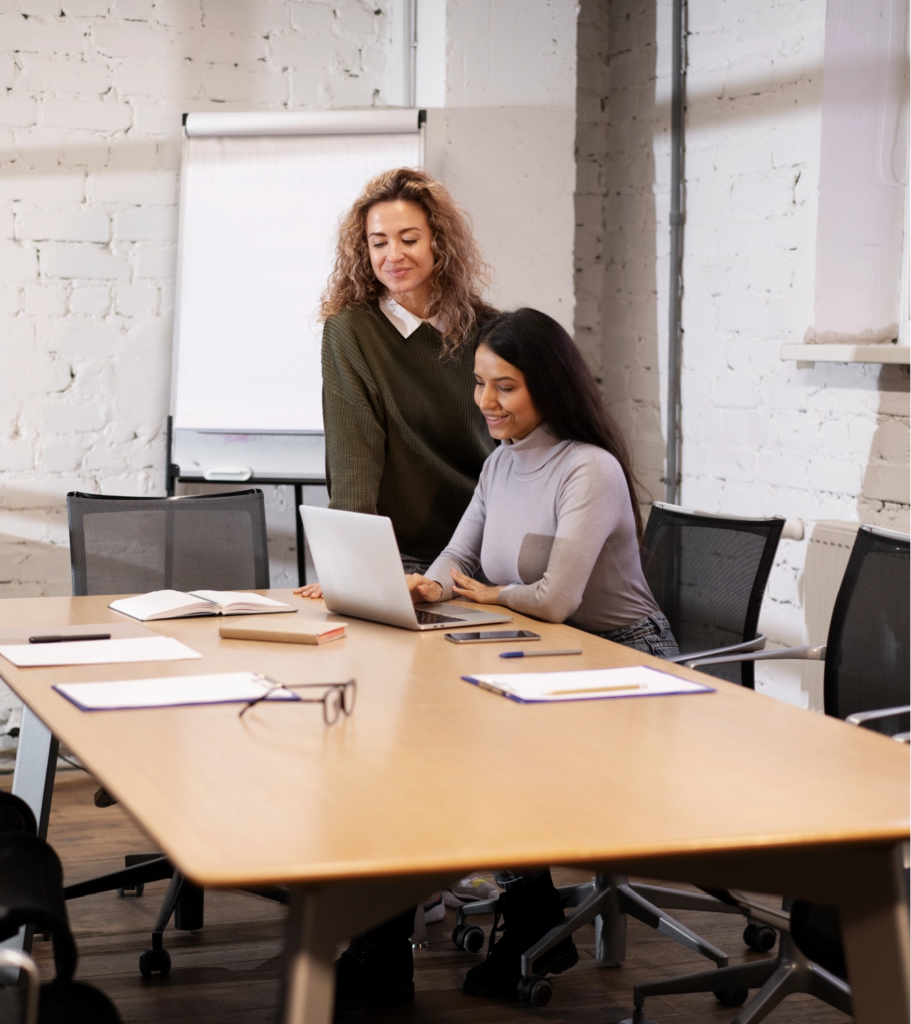 Two professional women discussing Master vs MBA options